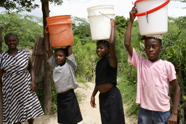 haitian girls carrying water