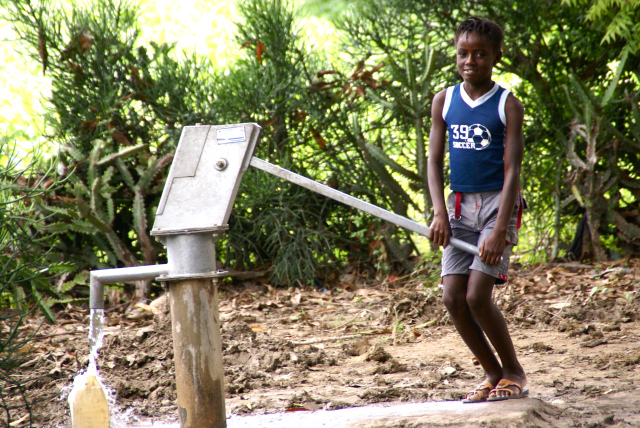 haitian girl at water pump